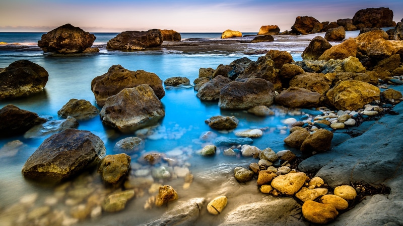 Rocky coastline with blue sea and sky