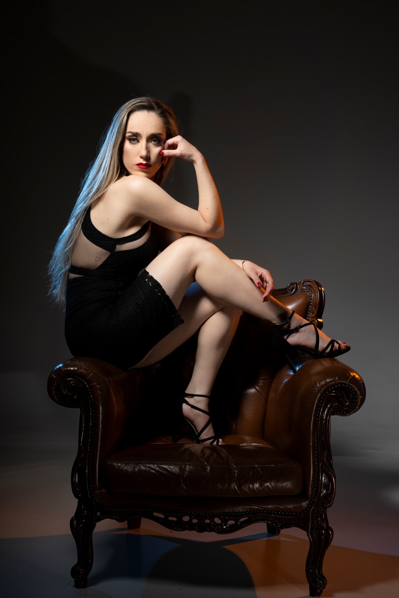 Francisca posing on a leather armchair