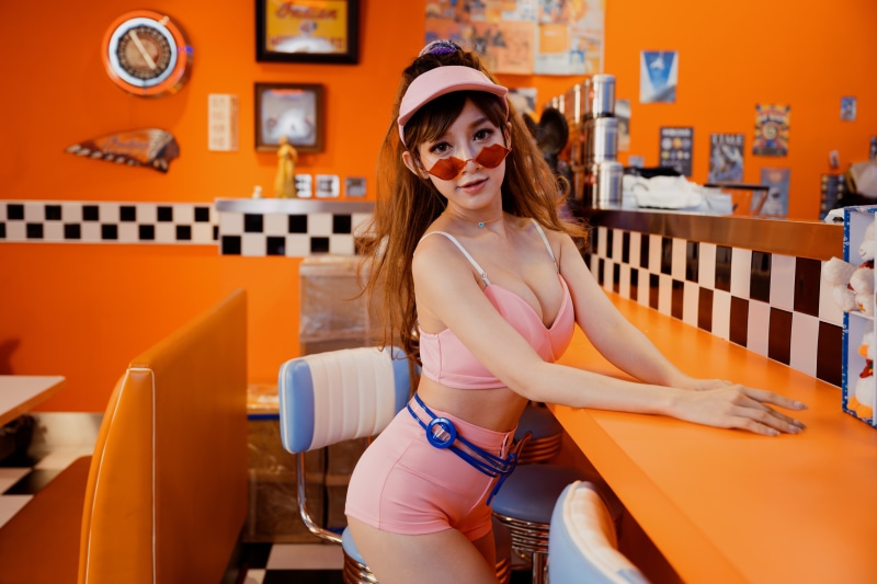 Asian woman in pink outfit at diner