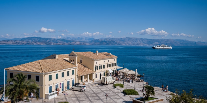 Corfu, Greece: Houses by the Sea with Mountains and Ferry