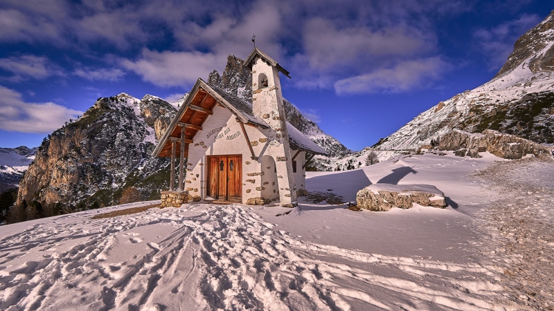 Small church in snowy mountains of Falzarego, Italy