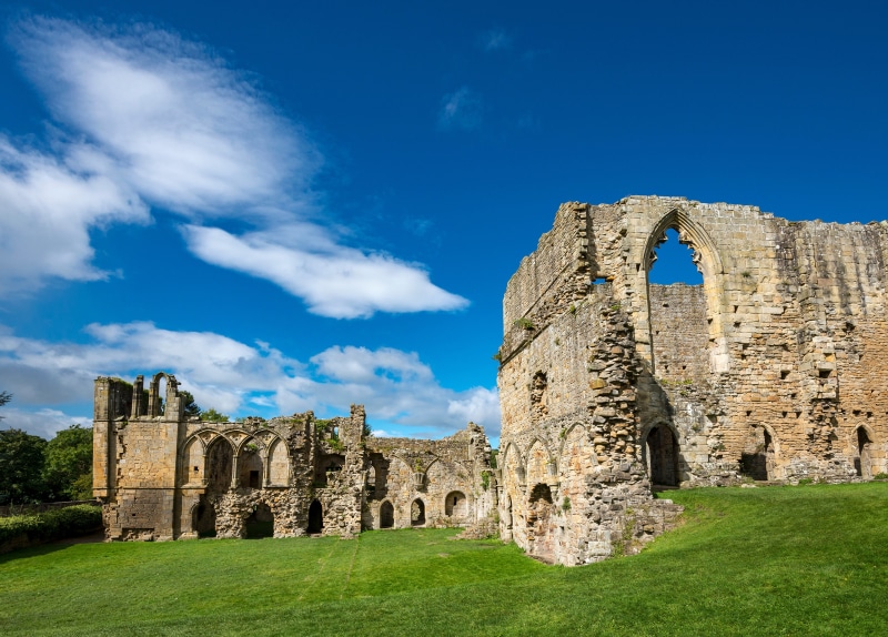 Easby Abbey Ruins in England under a blue sky