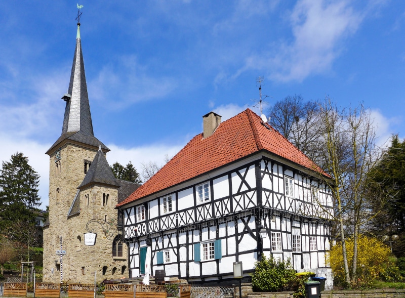 Half-timbered house and church tower in Wengern, Germany
