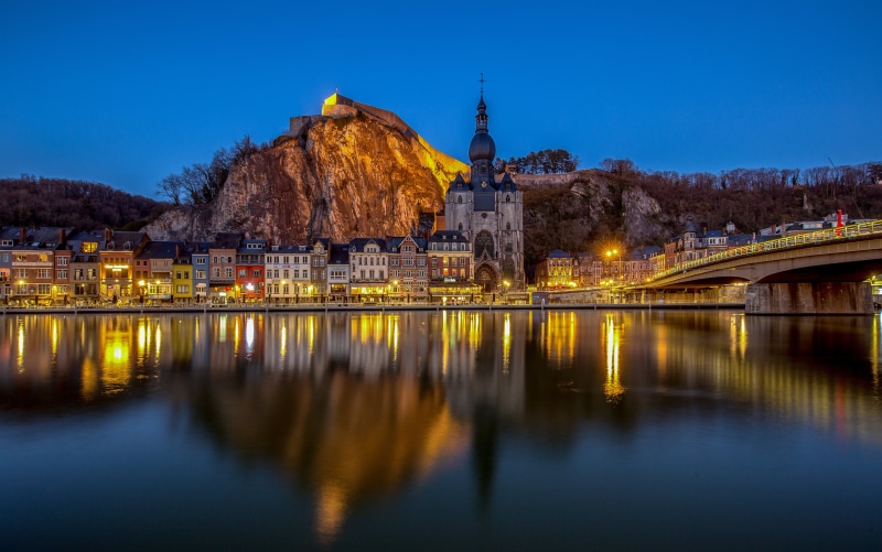 Dinant, Belgium cityscape with river and citadel at dusk