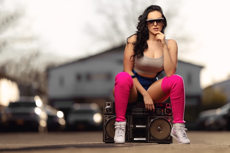Woman in athletic wear sitting on a boombox
