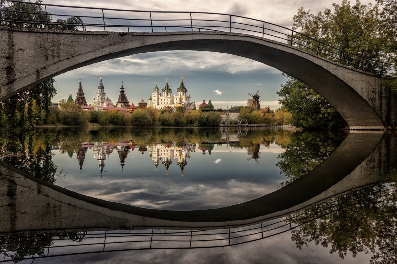 Izmailovo Kremlin reflected in river under bridge, Moscow, Russia