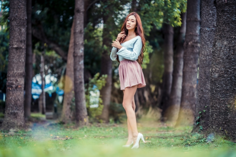 Asian woman with brown hair in a park