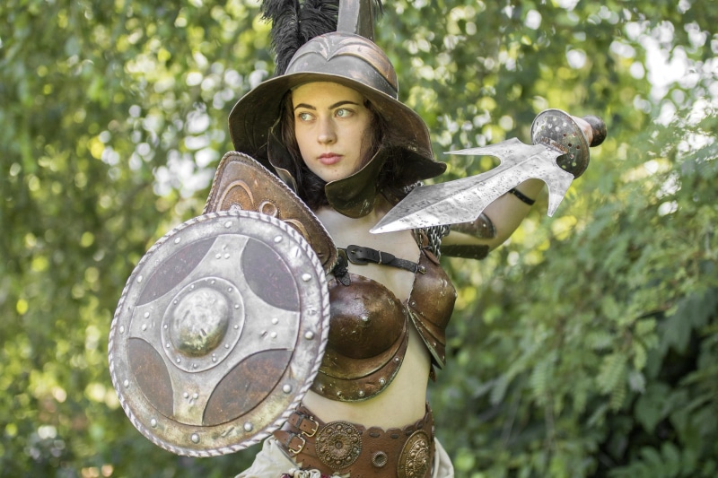 Woman in gladiator armor with shield and sword