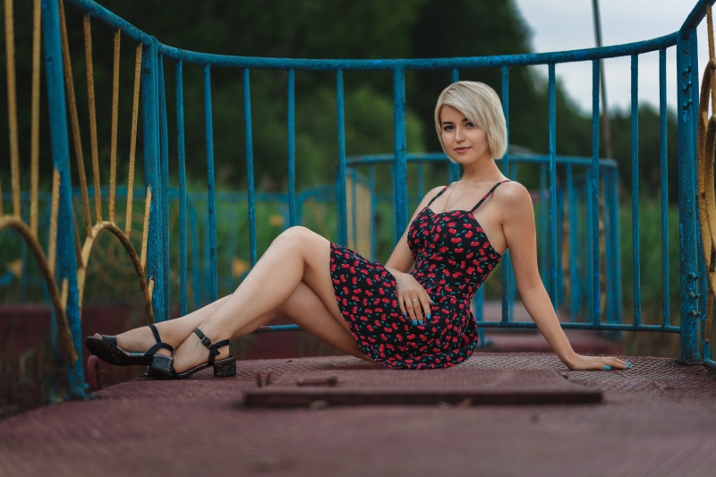 Anastasia blonde girl sitting on a playground structure