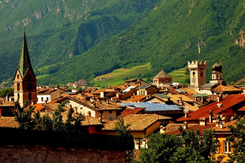 Town with church spires and mountains in Trento, Italy