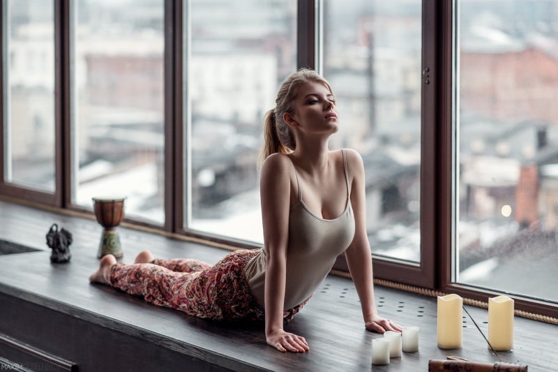 Irina Popova doing yoga by the window