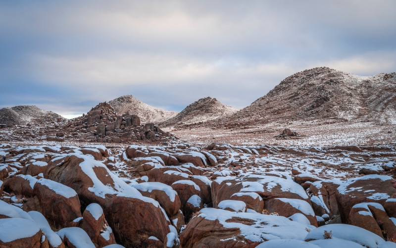 Snow-covered rocks and mountains in Alabama Hills, California