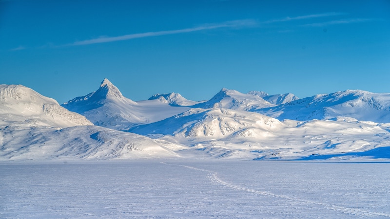 Snowy mountains and frozen lake in Norway