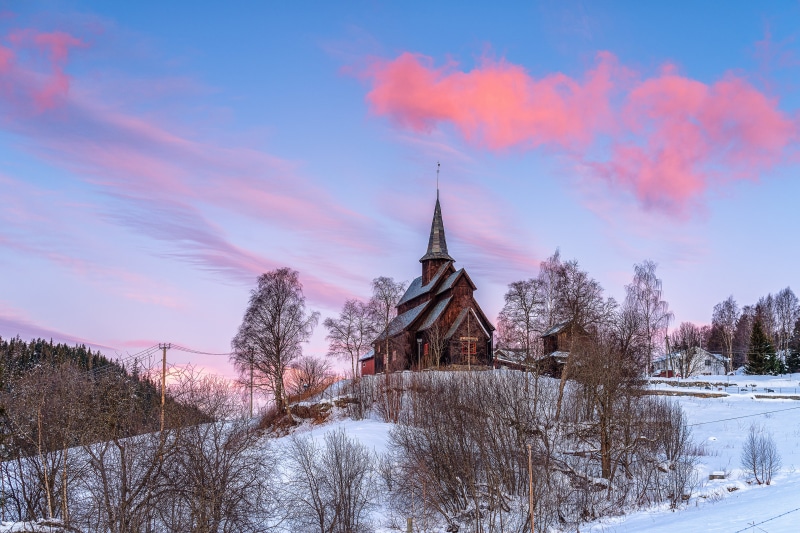 Wooden church in snow at sunset, Valdres, Norway