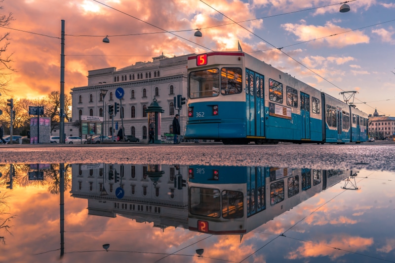 Tram 5 in Gothenburg, Sweden with reflection in puddle