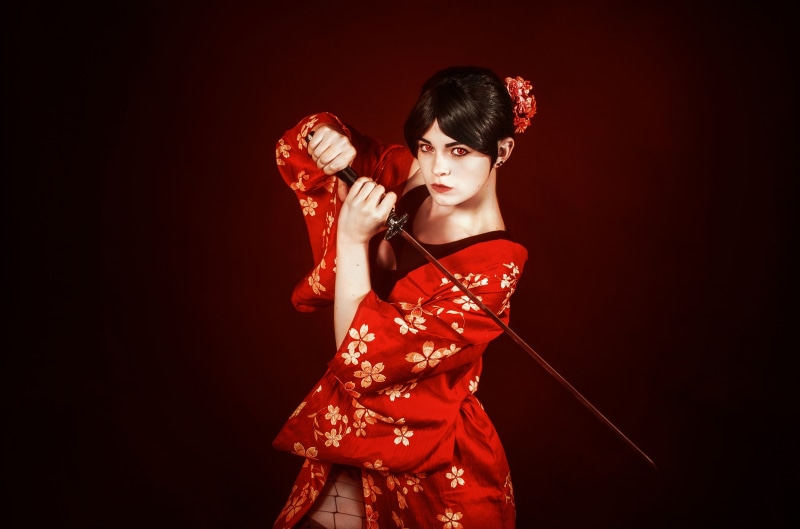 Woman in red kimono holding a sword