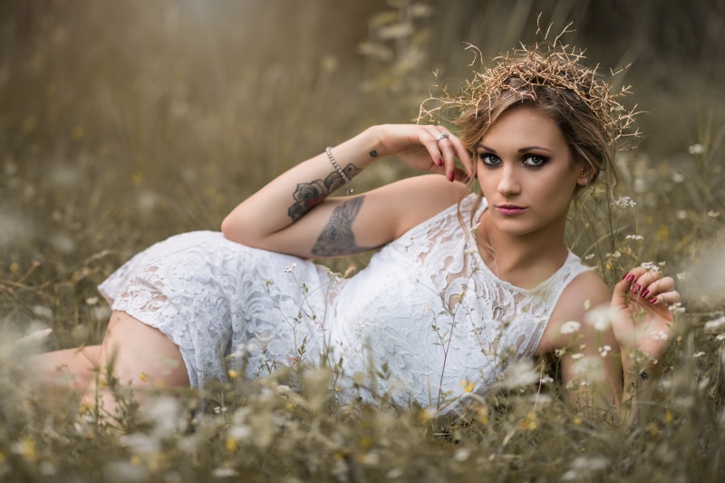 Woman with wreath lying in grass