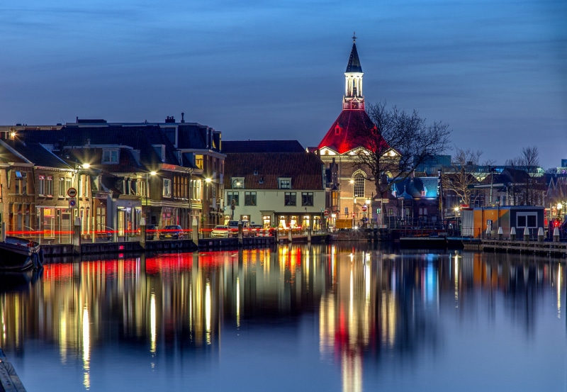 Houses and Church Reflected in Water at Night in Leidschendam