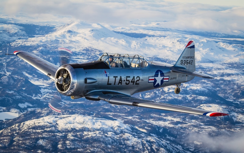 4K North American T-6 Texan Airplane Flying Over Mountains