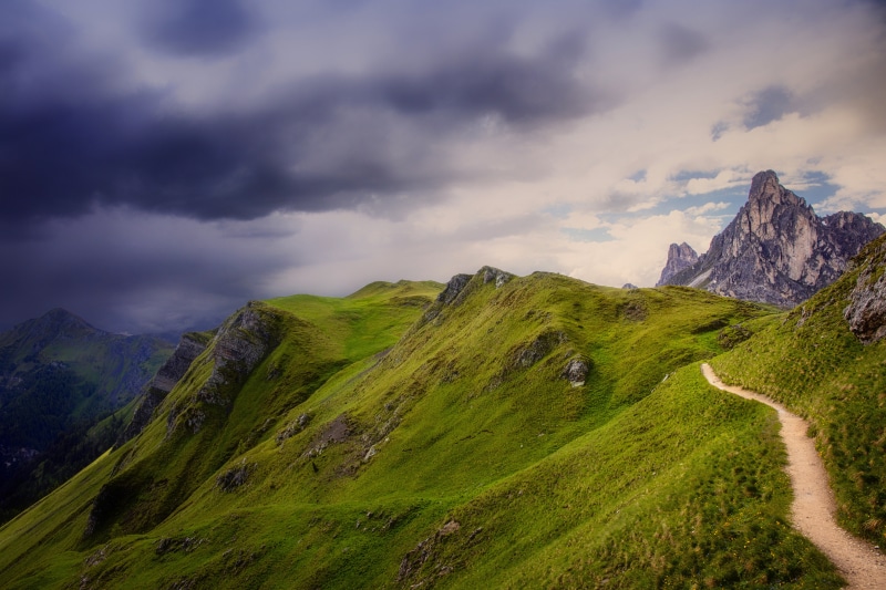 Mountain trail in the Dolomites, Italy under stormy clouds