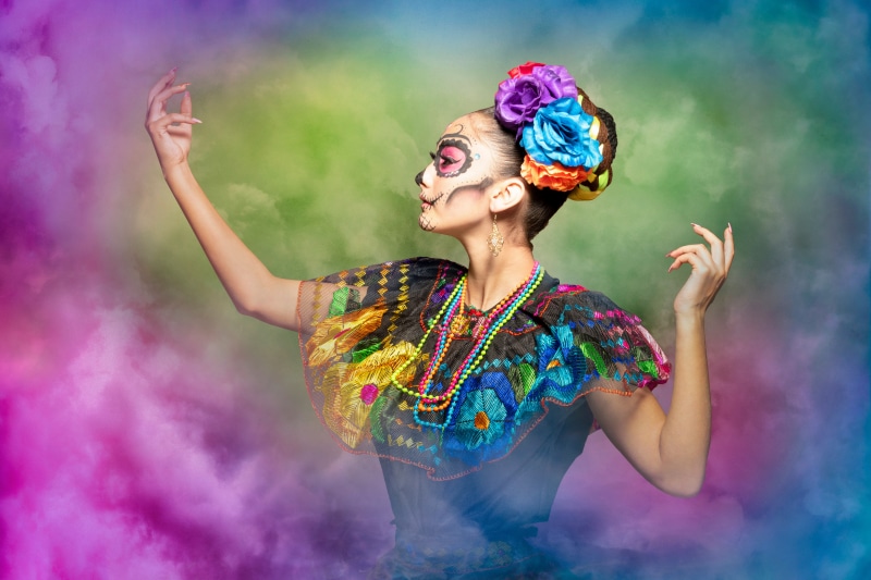 Woman with Day of the Dead makeup and flowers in hair