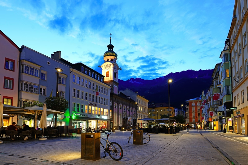 Innsbruck street scene with church tower at dusk