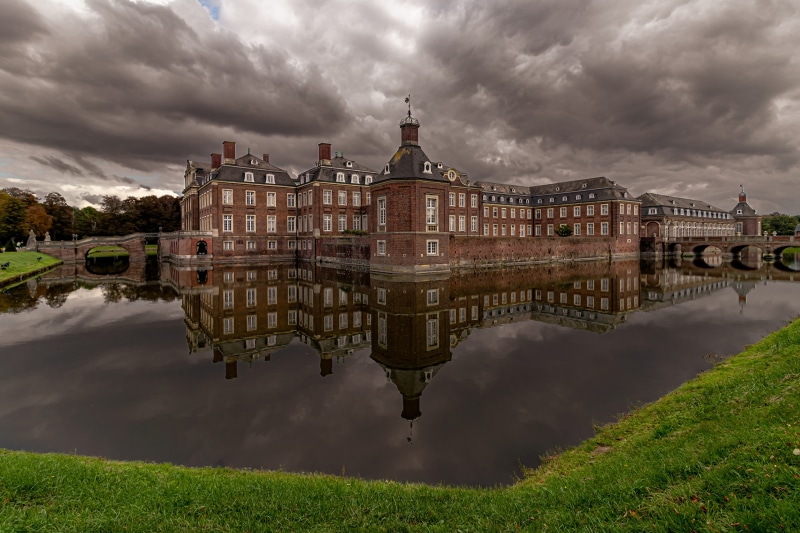 Nordkirchen Castle reflected in the pond under cloudy skies