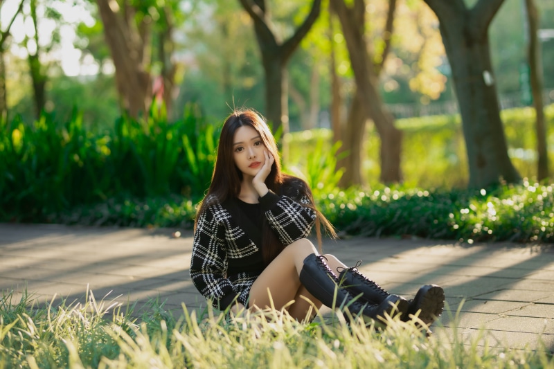Asian woman sitting in a park