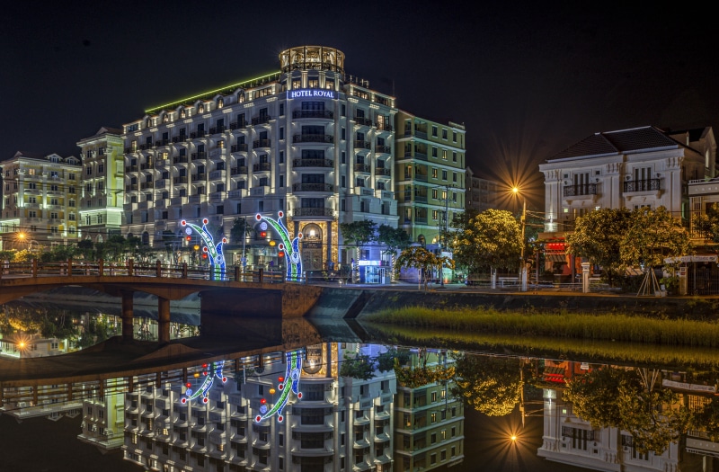Hotel Royal in Hoi An, Vietnam at night with river reflection