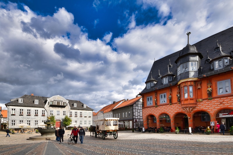 Town square in Goslar, Germany with historic buildings and carriage