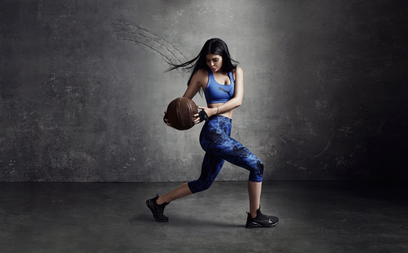 Kylie Jenner holding a medicine ball in Puma athletic wear