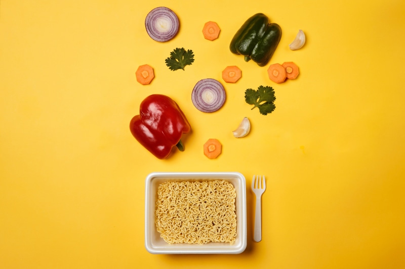 Instant noodles with vegetables and fork