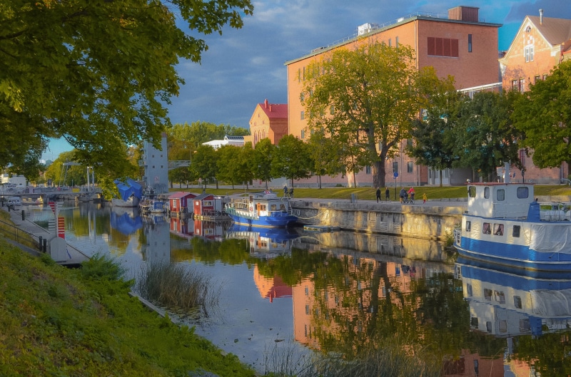 Boats docked on a canal in Uppsala, Sweden