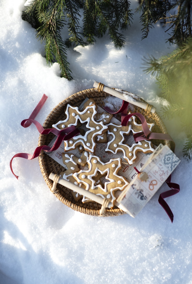 Christmas snowflake cookies in a basket on snow