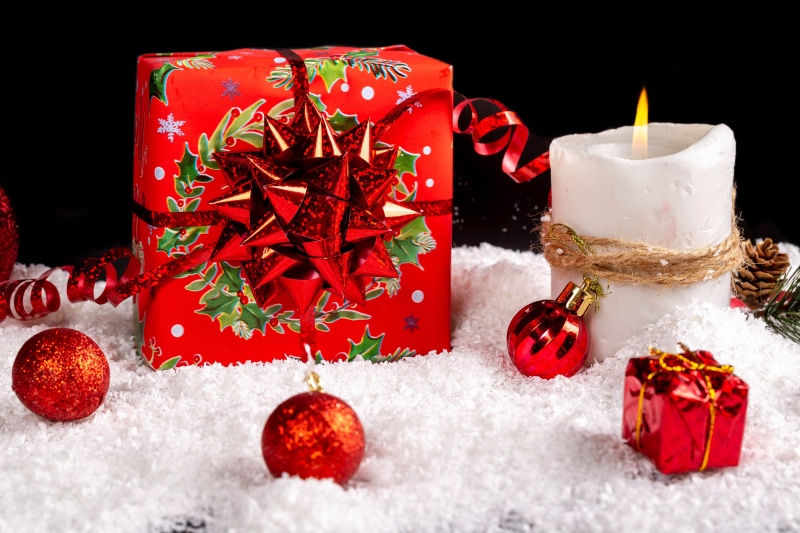 Christmas Gifts, Candle, and Ornaments in Snow