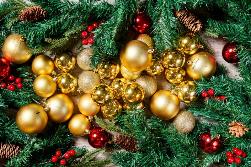 Christmas ornaments and pine cones on branches