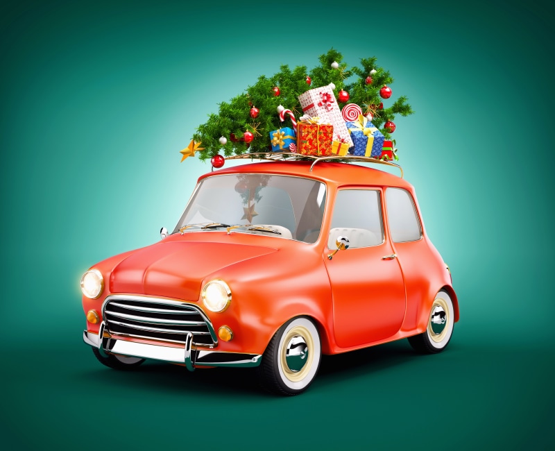 Red car with Christmas tree and gifts on roof