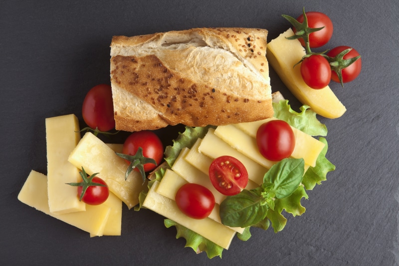 Bread, Cheese, and Tomatoes on a Gray Background