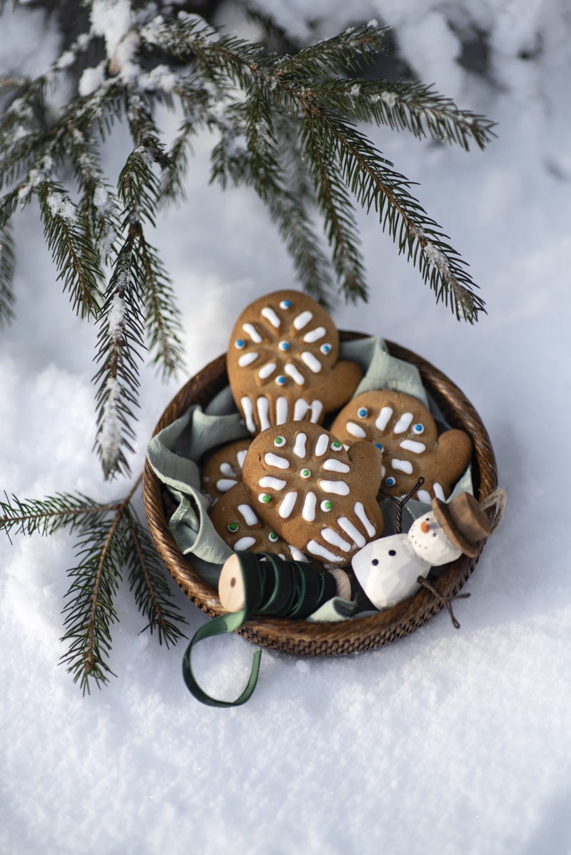 Christmas mitten cookies in a basket with a snowman ornament