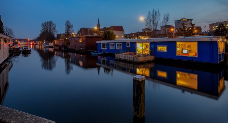 Houseboats on a canal in The Hague at dusk