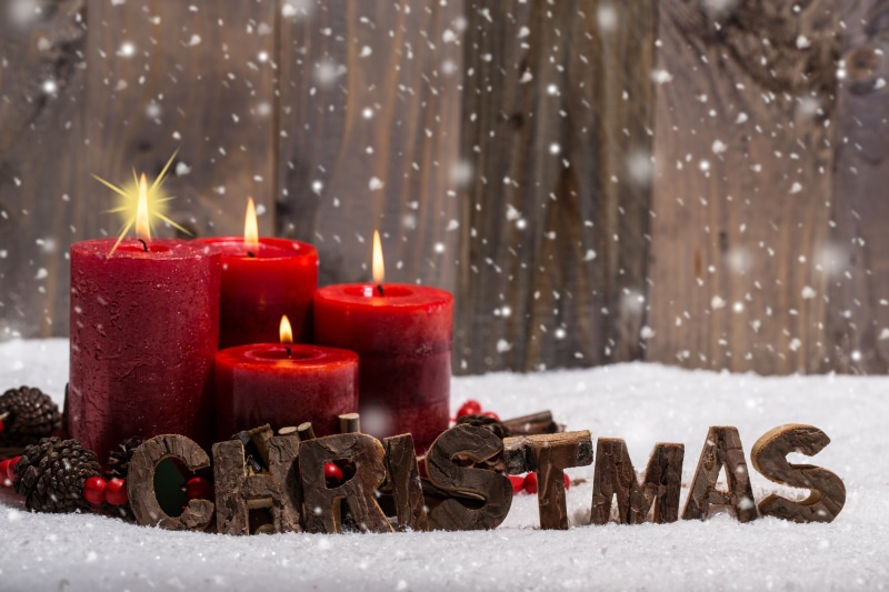 Christmas Candles in Snow with Wooden Background