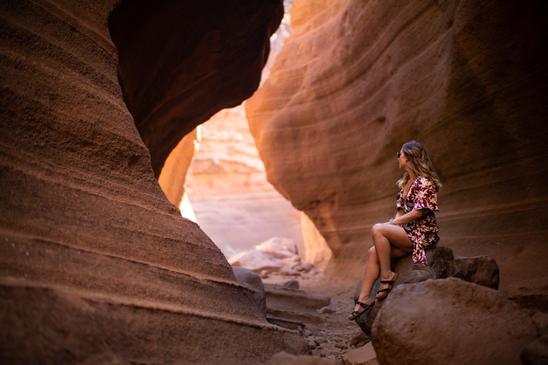 Woman sitting in a desert canyon