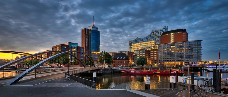 Hamburg skyline with bridge and river at dusk