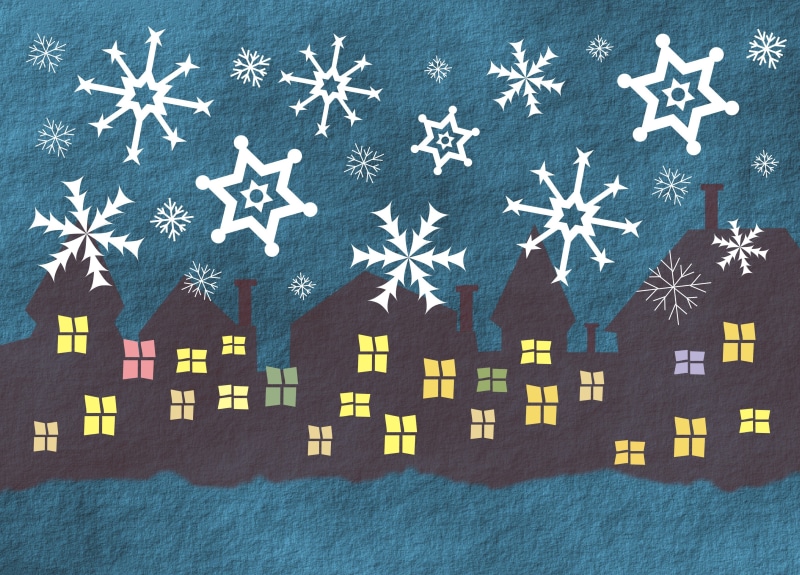 Snowflakes falling on houses at night