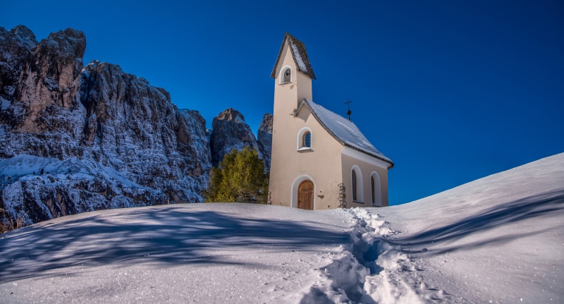 Church in the Dolomites, Italy, with Snow and Footprints