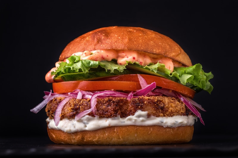 Hamburger with fresh ingredients on black background