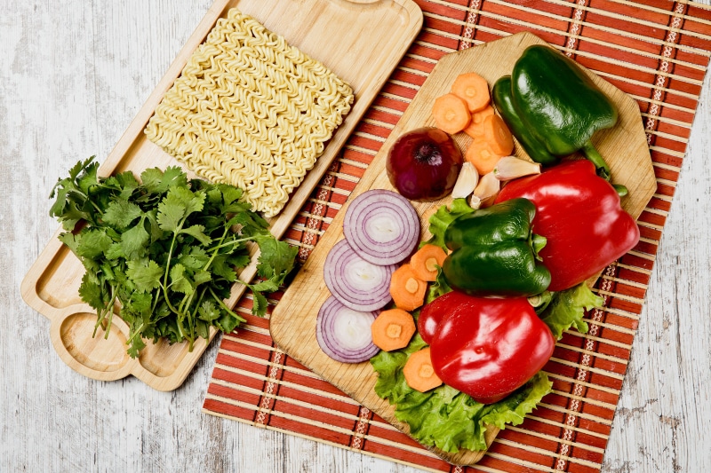 4K Noodles and Vegetables on Cutting Board