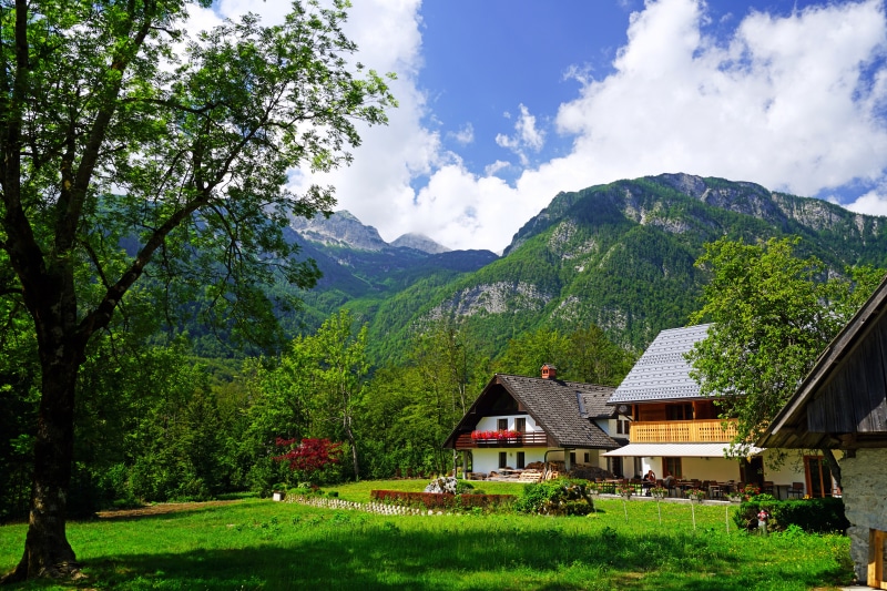 Houses in Ukanc, Slovenia with Mountains and Clouds