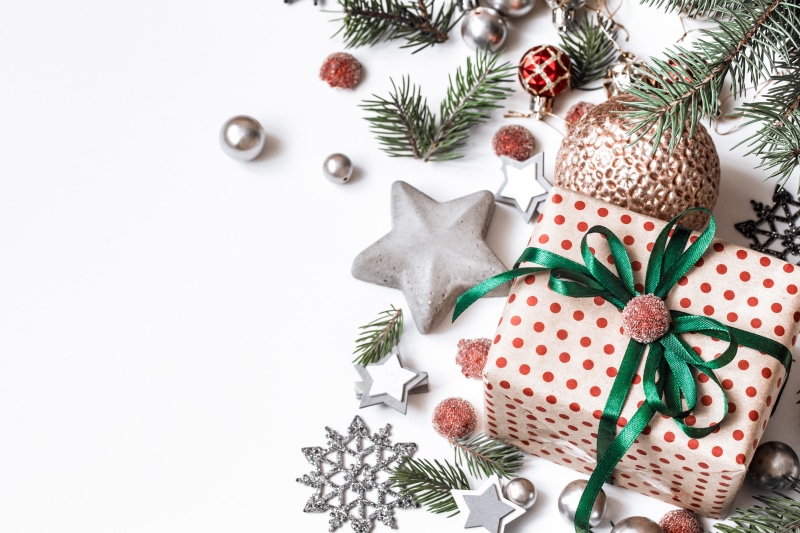 Christmas gift with ornaments and pine branches