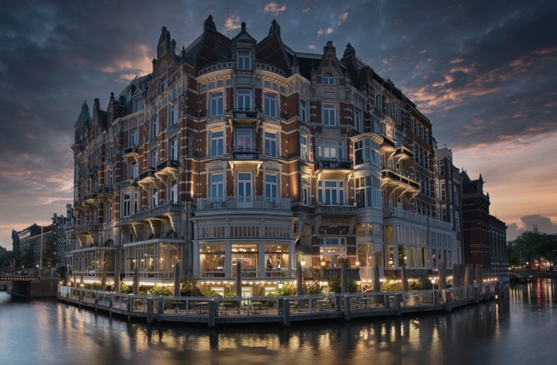 Hotel De L'Europe on a canal in Amsterdam at dusk